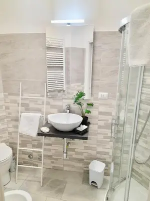 a bathroom with a sink and a shower at Rome Central Colosseum Flat in Rome