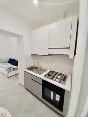 a living room with a bed and a table and a tv at Rome Central Colosseum Flat in Rome