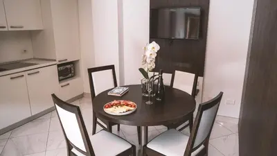 a dining room table with a plate of food on it at Morin 10 Rome Exclusive Suites in Rome