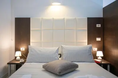 a bedroom with a large bed with two pillows at Morin 10 Rome Exclusive Suites in Rome