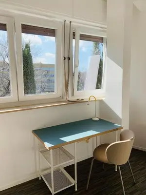 a desk and two chairs in a room with two windows at Apartment SIX Rome Flaminio - Villaggio Olimpico in Rome
