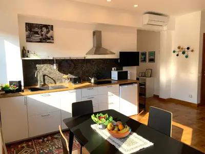 a kitchen with a table with a bowl of fruit on it at Apartment SIX Rome Flaminio - Villaggio Olimpico in Rome