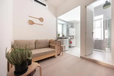 a living room with a couch and a table with a plant at Casa Chiagio in Rome