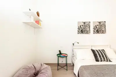 a bedroom with a bed and zebra prints on the wall at Casa Chiagio in Rome