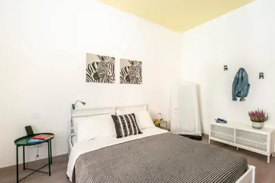 a bedroom with a bed and two paintings on the wall at Casa Chiagio in Rome
