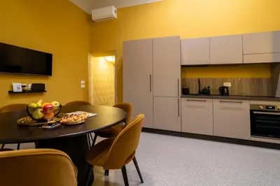 a kitchen with a table with a plate of food on it at Maison Luxury Plaza in Rome