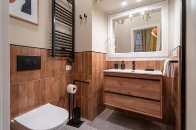 a bathroom with a toilet and a sink and a mirror at Maison Luxury Plaza in Rome