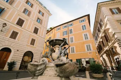 a statue in the middle of a street with buildings at Maison Luxury Plaza in Rome
