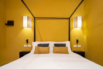 a bedroom with a white bed with two pillows at Maison Luxury Plaza in Rome