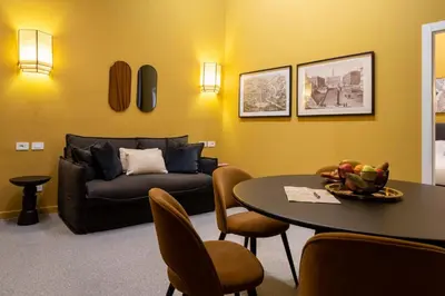 a living room with a couch and a table at Maison Luxury Plaza in Rome
