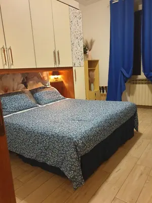 a bedroom with a bed with a blue comforter at Holiday Season in Rome