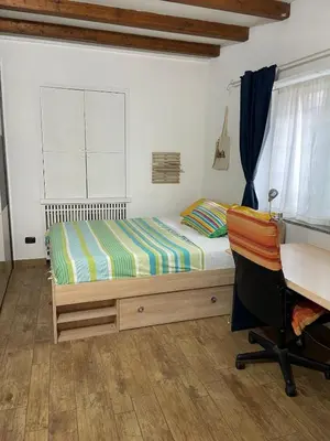 a bedroom with a bed and a desk and a chair at Cozy house with terrace in Rome