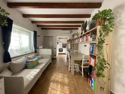 a living room with a couch and a table at Cozy house with terrace in Rome