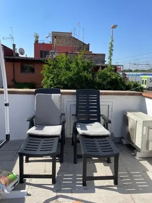 two chairs sitting on top of a patio at Cozy house with terrace in Rome