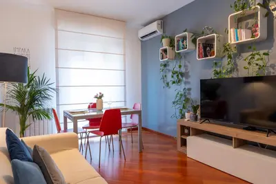 a living room with a television and a table with chairs at Apartment Casa Girina Boutique in Rome