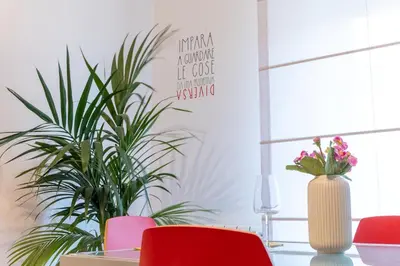 a dining room with red chairs and a table with plants at Apartment Casa Girina Boutique in Rome