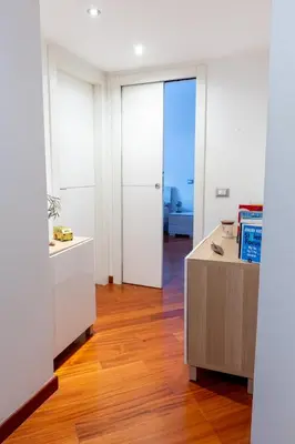 a room with white walls and a wooden floor at Apartment Casa Girina Boutique in Rome