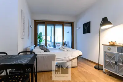 a bedroom with a bed and a table and chairs at Nuovo appartamento stazione Tiburtina in Rome