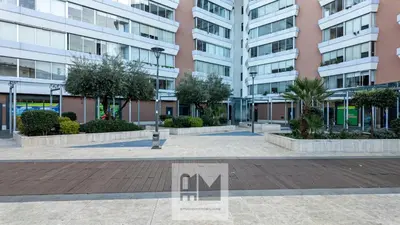 a courtyard in a building with trees and buildings at Nuovo appartamento stazione Tiburtina in Rome