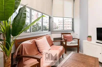 a living room with a couch and some windows at Nuovo appartamento stazione Tiburtina in Rome