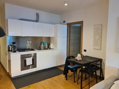 a small kitchen with a table and a stove at Nuovo appartamento stazione Tiburtina in Rome