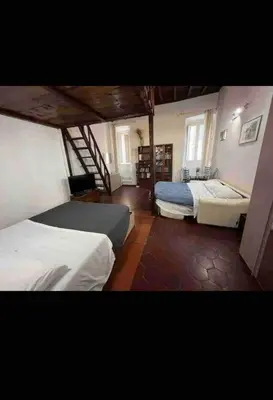 a large room with two beds and a staircase at Nice apartment in the historic center in Rome