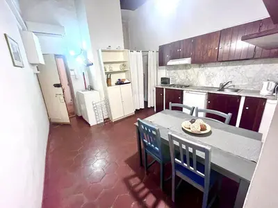 a kitchen with a table and chairs and a refrigerator at Nice apartment in the historic center in Rome