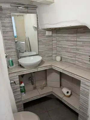 a small bathroom with a sink and a mirror at Nice apartment in the historic center in Rome