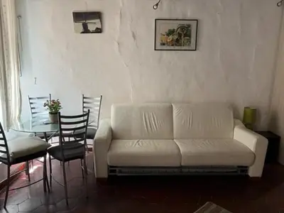a living room with a couch and a table with chairs at Nice apartment in the historic center in Rome