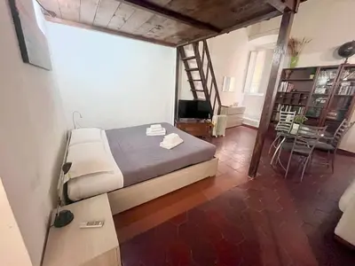 a bedroom with a bed and a staircase in a room at Nice apartment in the historic center in Rome