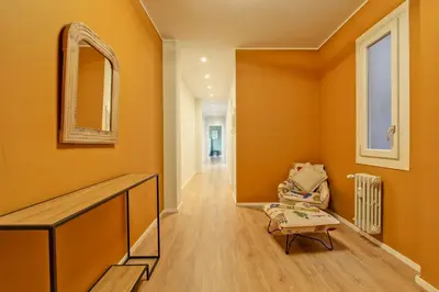 an orange hallway with a chair and a mirror at Design Monteverde Flat Jenner 70 in Rome