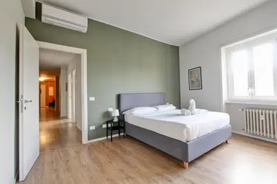 a bedroom with a large bed and a hallway at Design Monteverde Flat Jenner 70 in Rome