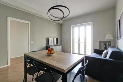 a living room with a table and a blue couch at Design Monteverde Flat Jenner 70 in Rome