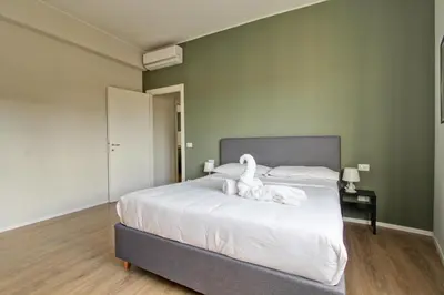 a bedroom with a bed with white towels on it at Design Monteverde Flat Jenner 70 in Rome
