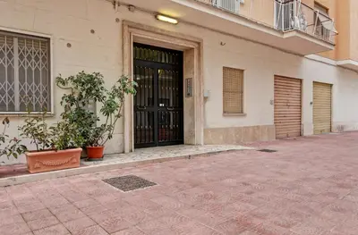 a building with a black door and two plants at Design Monteverde Flat Jenner 70 in Rome