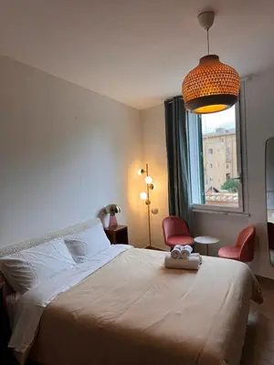 a bedroom with a large bed and a window at Garibaldi Studio Apt in Rome