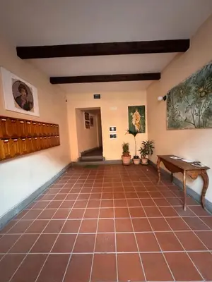 a room with a tiled floor and a table at Garibaldi Studio Apt in Rome