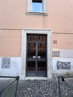 a door to a building with graffiti on it at Garibaldi Studio Apt in Rome