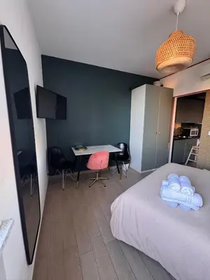 a bedroom with a bed and a desk and a table at Garibaldi Studio Apt in Rome