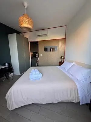 a bedroom with a bed with two towels on it at Garibaldi Studio Apt in Rome