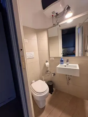a small bathroom with a toilet and a sink at Garibaldi Studio Apt in Rome