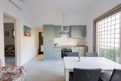 a kitchen and dining room with a table and chairs at Rose of pyramid in Rome
