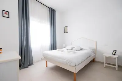 a white bedroom with a white bed and a window at Rose of pyramid in Rome