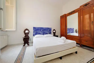 a bedroom with a large bed and a mirror at Carlo Felice in Rome