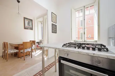 a kitchen with a stove top oven in a room at Carlo Felice in Rome