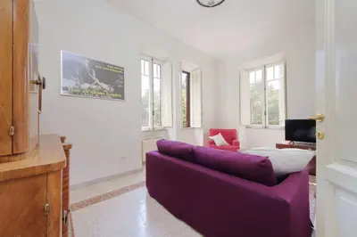 a living room with a purple couch and a tv at Carlo Felice in Rome
