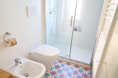 a bathroom with a shower and a toilet and a sink at Cozy Pigneto Flat with Balcony in Rome