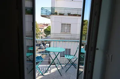 a view of a balcony with a table and a building at Cozy Pigneto Flat with Balcony in Rome