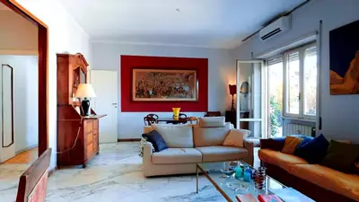 a living room with a couch and a red wall at FIORELLA's TERRACE in Rome
