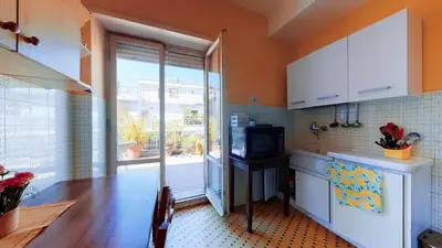 a kitchen with a table and a television and a window at FIORELLA's TERRACE in Rome